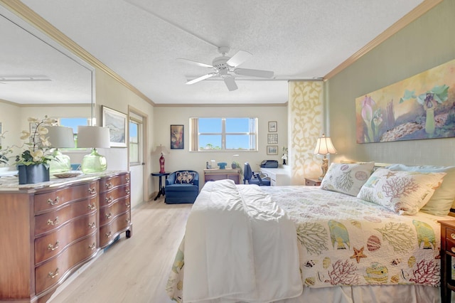 bedroom with light wood-style floors, ceiling fan, a textured ceiling, and ornamental molding