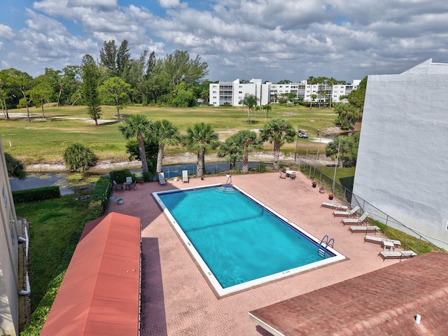 pool with a patio area and fence