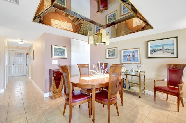 dining room with baseboards and light tile patterned floors