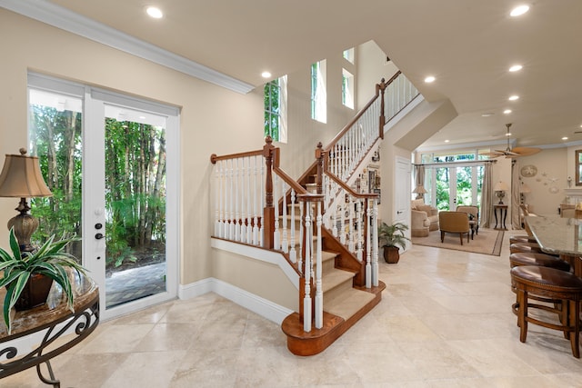 entrance foyer featuring a wealth of natural light, ornamental molding, stairs, and recessed lighting