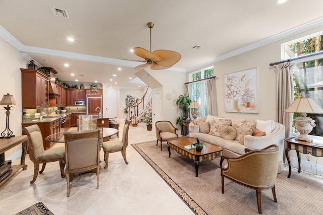 living room with ornamental molding, a healthy amount of sunlight, stairs, and visible vents