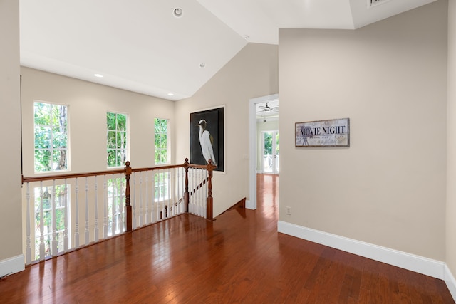 interior space with high vaulted ceiling, an upstairs landing, wood finished floors, baseboards, and recessed lighting