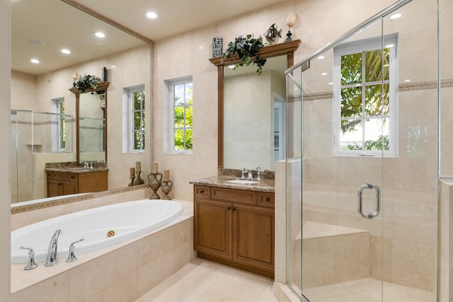 bathroom featuring a wealth of natural light, a whirlpool tub, and a stall shower