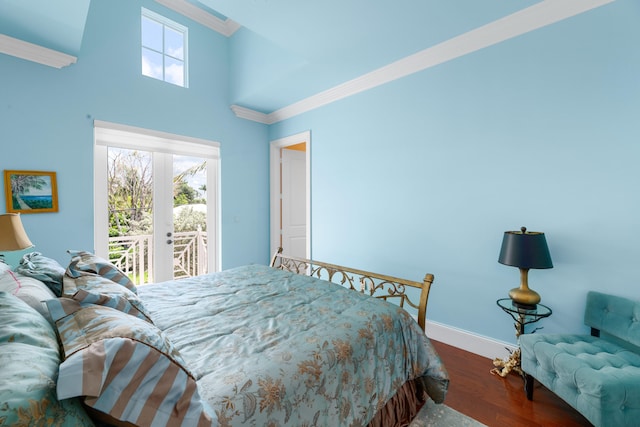 bedroom with dark wood-type flooring, crown molding, baseboards, and access to outside