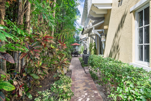 view of side of property with a patio area and stucco siding