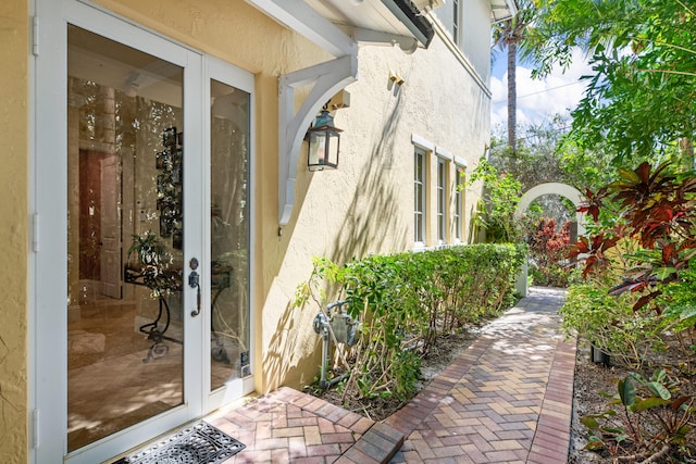 entrance to property with stucco siding and french doors