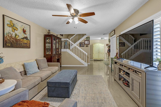 living area featuring a textured ceiling, stairs, and a ceiling fan