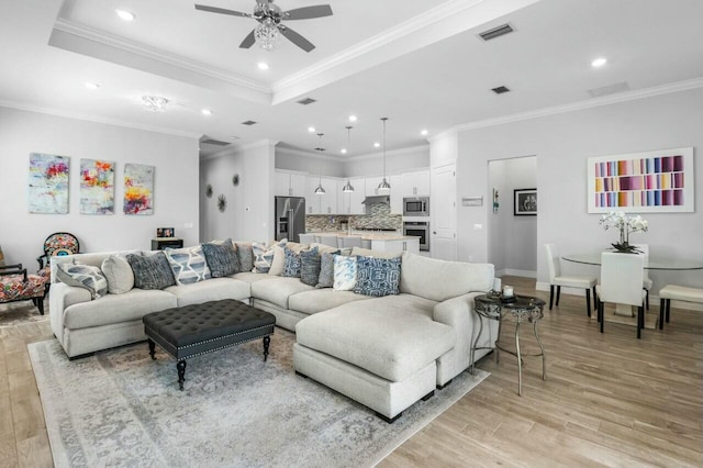 living room with a ceiling fan, light wood finished floors, visible vents, and recessed lighting