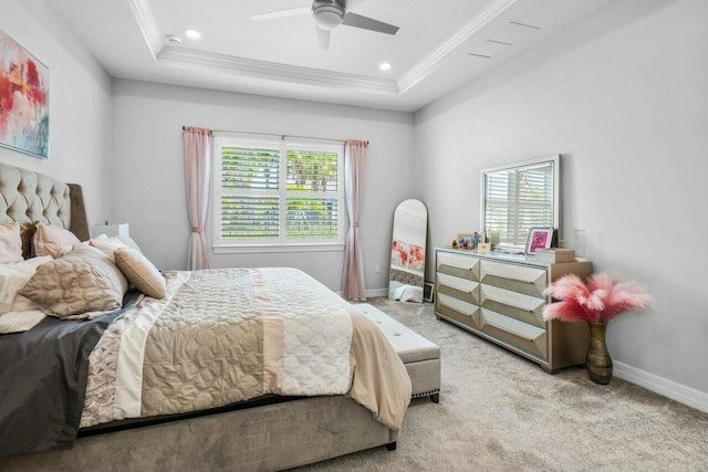 bedroom featuring a tray ceiling, baseboards, carpet flooring, and multiple windows