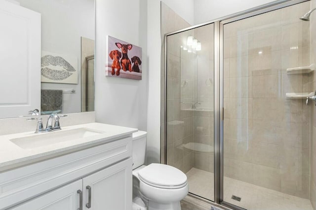 full bath with a shower stall, toilet, and vanity