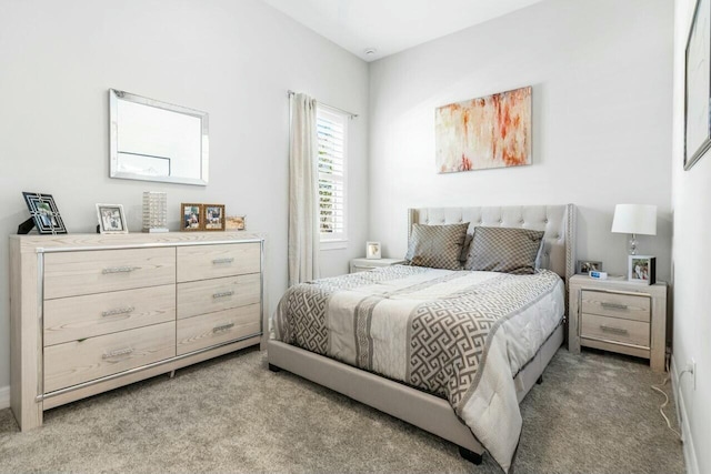 bedroom featuring light carpet
