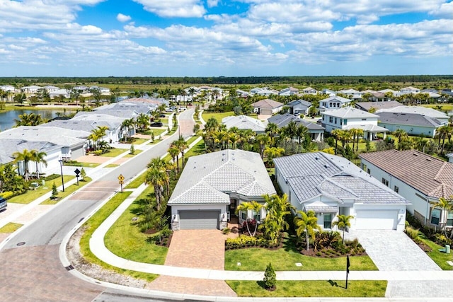 birds eye view of property featuring a water view and a residential view