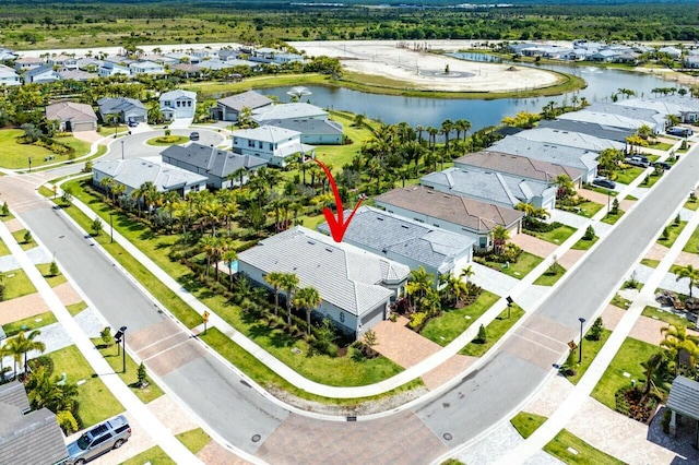bird's eye view with a residential view and a water view