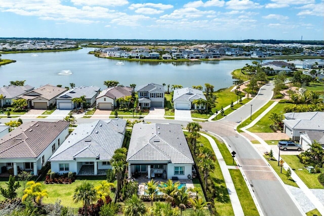 drone / aerial view featuring a residential view and a water view
