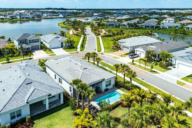 drone / aerial view with a water view and a residential view