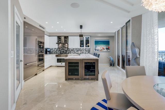 3740 S Ocean Blvd Unit 1205, Highland Beach, FL 33487 - kitchen with white cabinets, beverage cooler, appliances with stainless steel finishes, and decorative backsplash