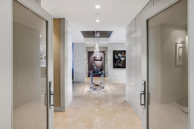 3740 S Ocean Blvd Unit 1205, Highland Beach, FL 33487 - corridor with a tray ceiling and baseboards