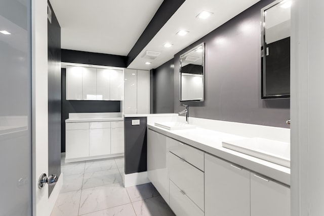 full bath with recessed lighting, marble finish floor, double vanity, visible vents, and a sink
