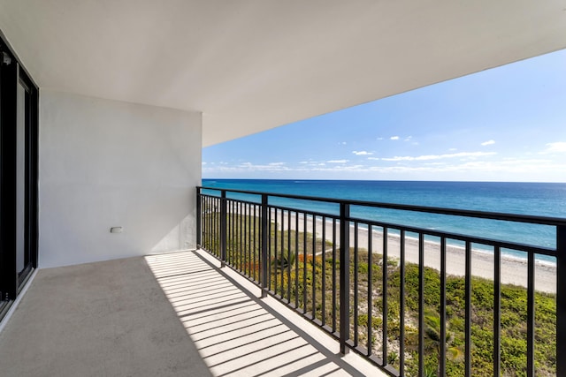 balcony with a beach view and a water view
