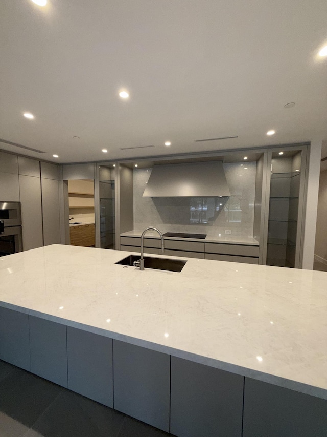 220 SE Mizner Blvd Unit 204, Boca Raton, FL 33432 - kitchen with modern cabinets, recessed lighting, custom range hood, a sink, and gray cabinetry