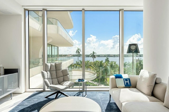 sunroom featuring a water view