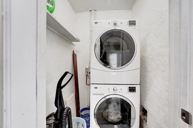 946 Paseo Morella, West Palm Beach, FL 33405 - laundry area with stacked washer and clothes dryer and a textured wall