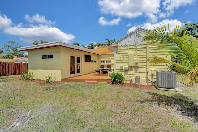 946 Paseo Morella, West Palm Beach, FL 33405 - rear view of house with central air condition unit, a deck, and stucco siding