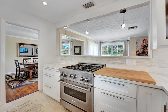 946 Paseo Morella, West Palm Beach, FL 33405 - kitchen with high end stainless steel range, ornamental molding, backsplash, plenty of natural light, and recessed lighting