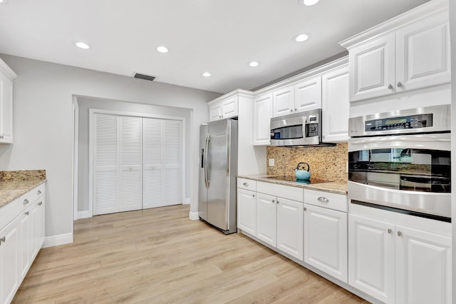 kitchen with light wood-type flooring, appliances with stainless steel finishes, and recessed lighting