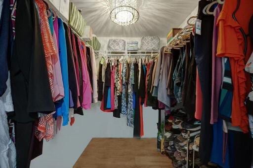 walk in closet with a notable chandelier
