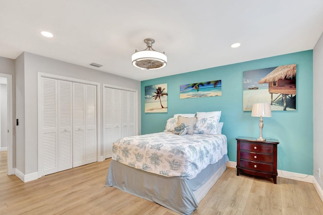 bedroom featuring wood finished floors, baseboards, visible vents, and recessed lighting