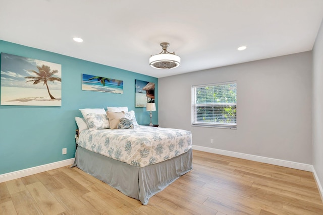 bedroom with baseboards, recessed lighting, and wood finished floors