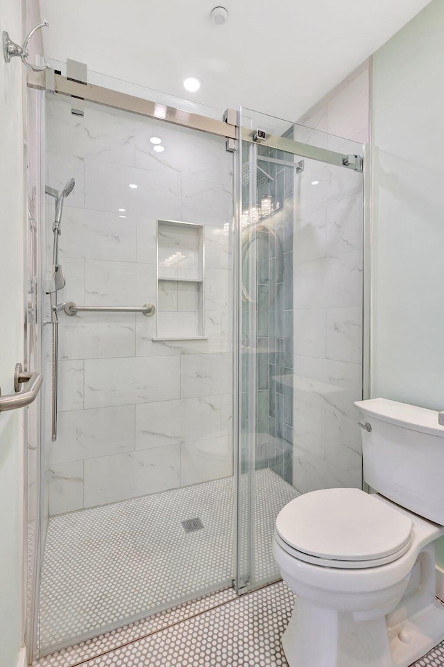 full bath with toilet and a shower stall