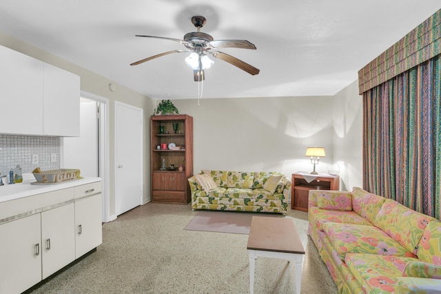 living room featuring a ceiling fan and light speckled floor