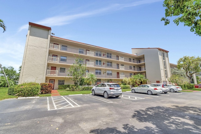 25 Abbey Ln Unit 404, Delray Beach, FL 33446 - view of apartment building / complex with uncovered parking