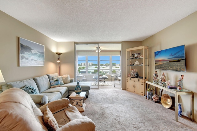 25 Abbey Ln Unit 404, Delray Beach, FL 33446 - living room featuring carpet floors, a textured ceiling, and a ceiling fan