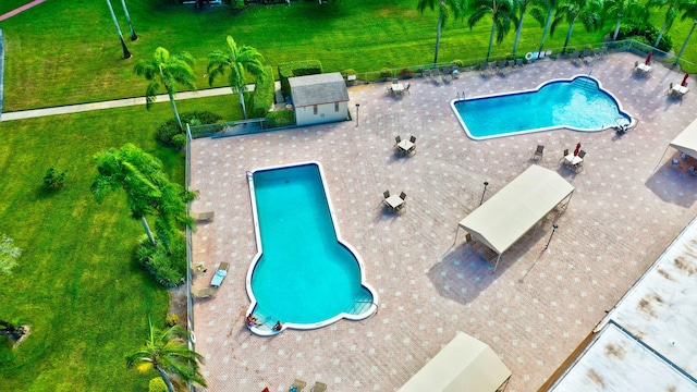 25 Abbey Ln Unit 404, Delray Beach, FL 33446 - community pool featuring a patio area and fence