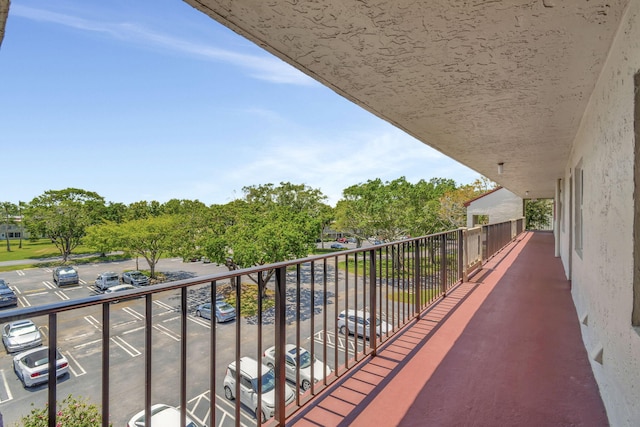 25 Abbey Ln Unit 404, Delray Beach, FL 33446 - hallway with a textured ceiling, tile patterned floors, and baseboards
