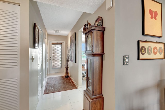 25 Abbey Ln Unit 404, Delray Beach, FL 33446 - hallway featuring light tile patterned flooring, baseboards, and light colored carpet