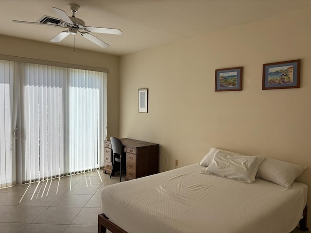 tiled bedroom featuring a ceiling fan