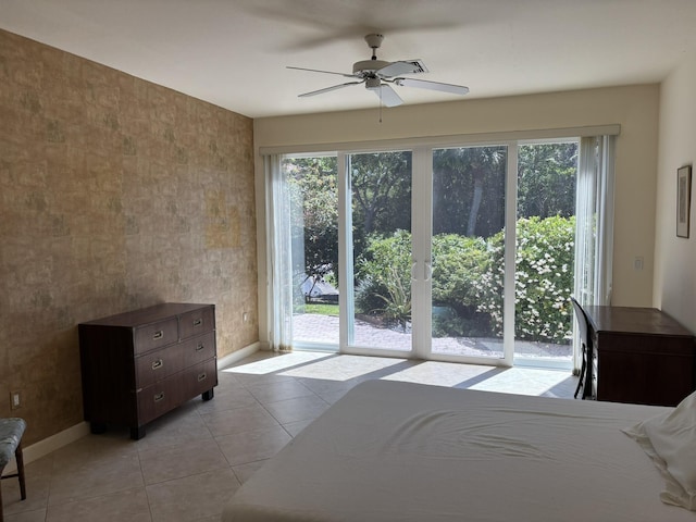 unfurnished bedroom featuring multiple windows, baseboards, and access to exterior