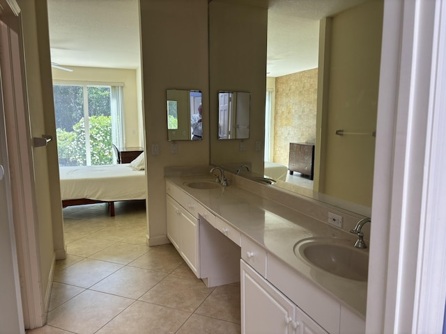 bathroom featuring double vanity, tile patterned floors, a sink, and connected bathroom