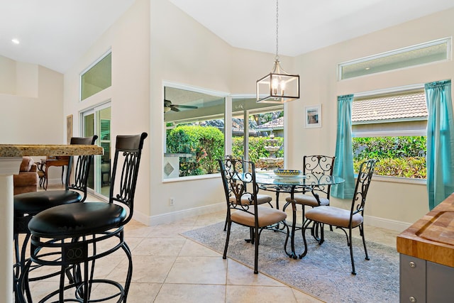1167 Egret Cir S, Jupiter, FL 33458 - dining area featuring light tile patterned flooring, ceiling fan, a chandelier, and a high ceiling