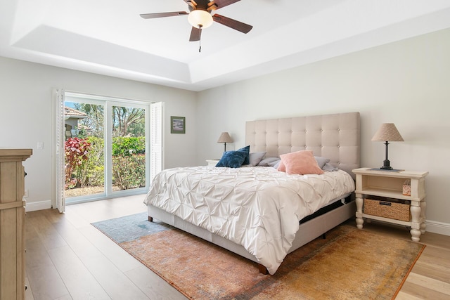 1167 Egret Cir S, Jupiter, FL 33458 - bedroom with a raised ceiling, access to outside, wood finished floors, and ceiling fan