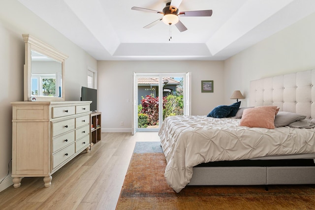 1167 Egret Cir S, Jupiter, FL 33458 - bedroom with a tray ceiling, light wood finished floors, access to outside, and a ceiling fan