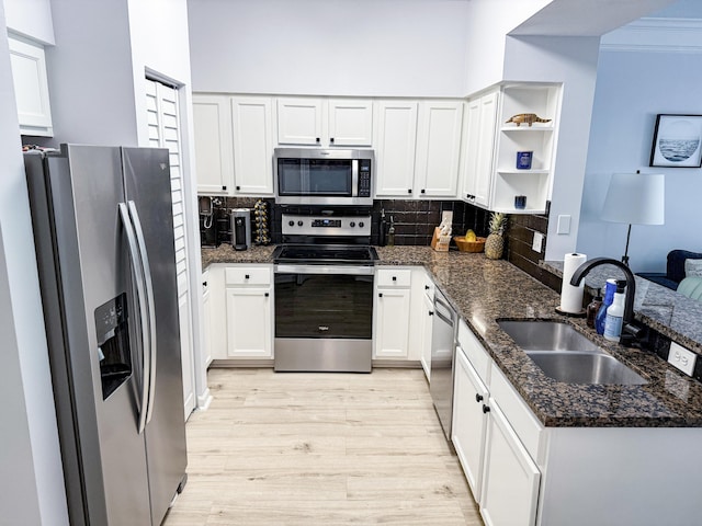 275 Murcia Dr Unit 304, Jupiter, FL 33458 - kitchen featuring appliances with stainless steel finishes, a sink, open shelves, a peninsula, and light wood-style floors