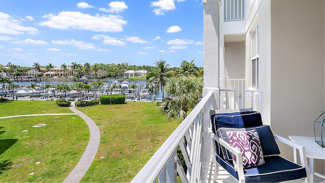 balcony featuring visible vents and a water view