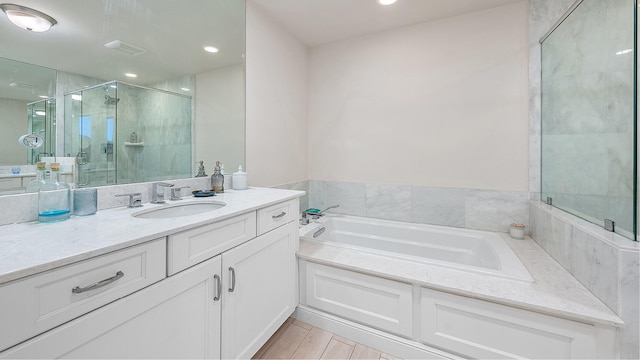 bathroom with a garden tub, vanity, recessed lighting, and a stall shower
