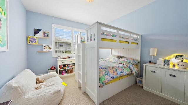 bedroom featuring light carpet