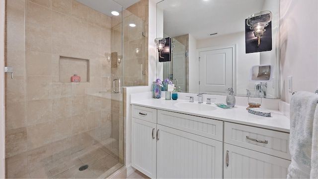 full bath featuring visible vents, vanity, and a stall shower